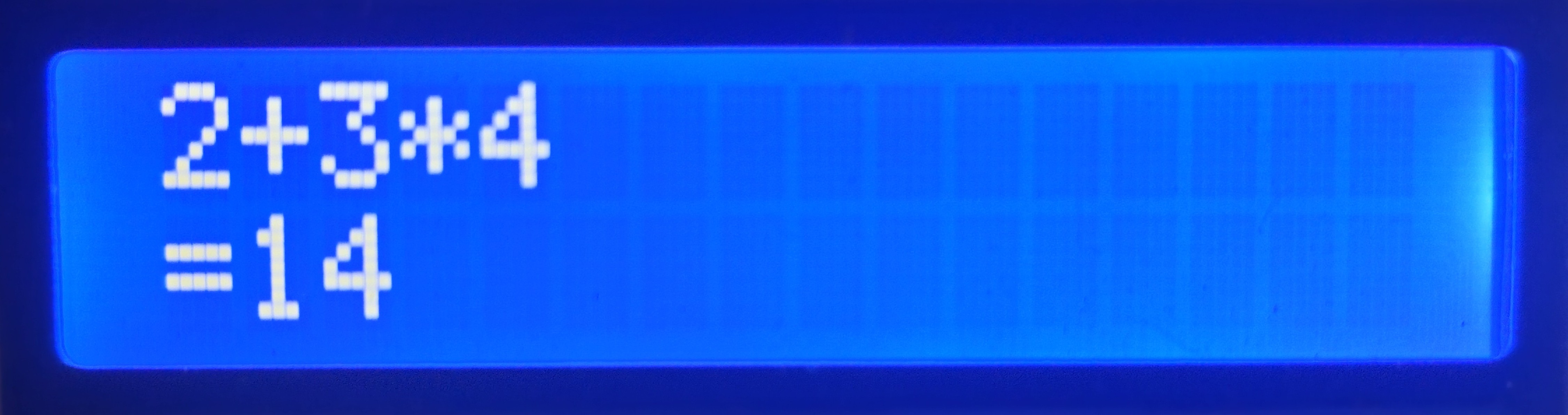 LCD showing the calculator view with the expression 2 plus 3 times 4 and its result 14