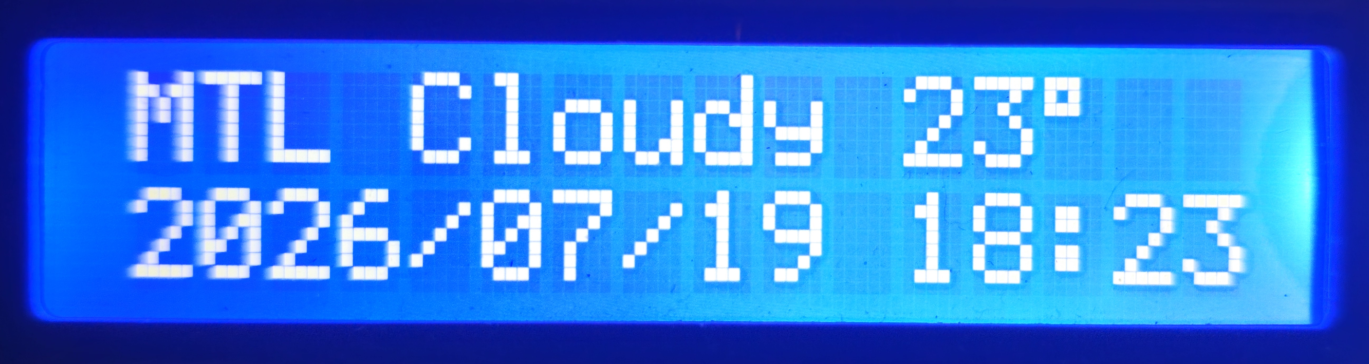 LCD clock view for Montreal: cloudy, 23 degrees, with date and time