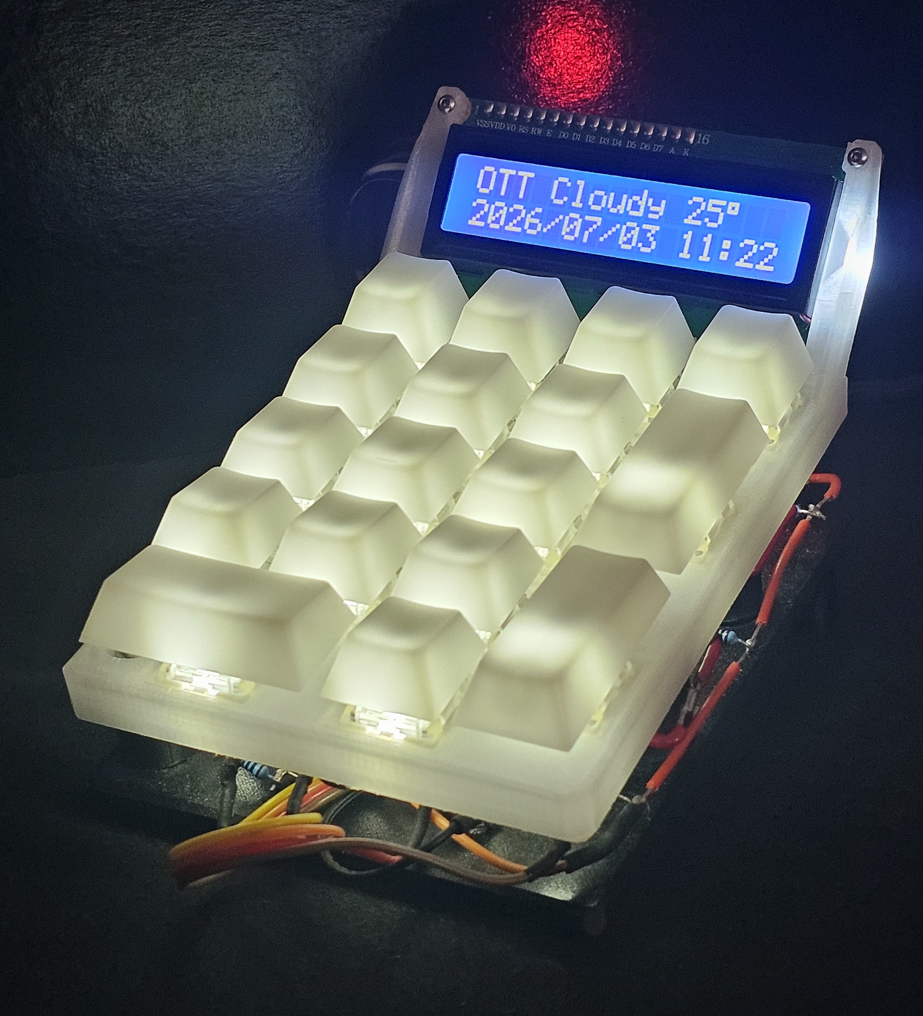 The finished LCD NumPad, translucent keycaps lit by per-key LEDs with the 16x2 LCD mounted above the keys